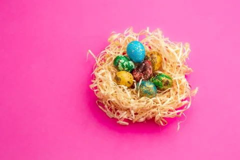 Painted easter eggs lie in a nest of shavings. Stock Photos