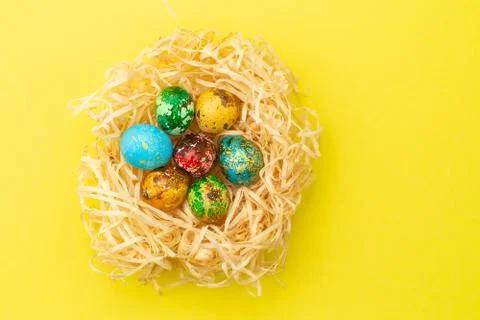 Painted easter eggs lie in a nest of shavings. Stock Photos