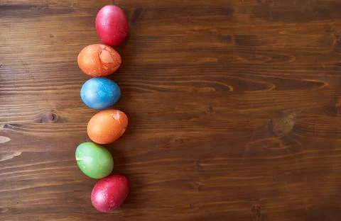 Painted Easter eggs lying on wood background Stock Photos