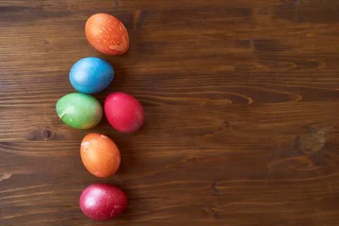 Painted Easter eggs lying on wood background Stock Photos