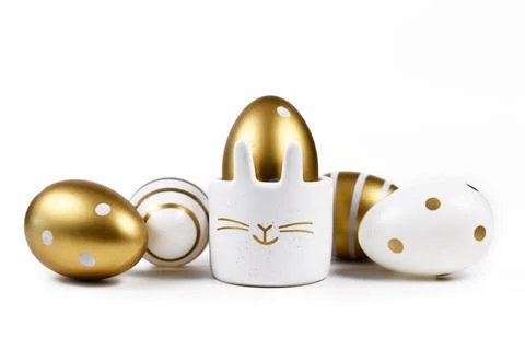 Painted easter eggs with metallic golden and white stripes and dots and cute Stock Photos