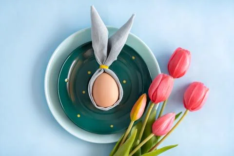 Painted Easter eggs with mixed color tulips arrangement on a wooden table f.. Stock Photos