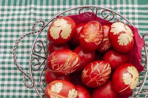 Painted Easter eggs in onion husks with abstract drawings are in a basket Stock Photos