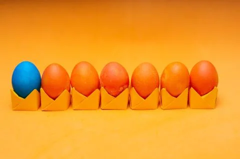 Painted easter eggs on origami stands in a row. Easter concept Stock Photos