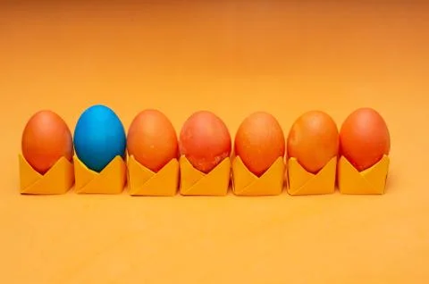 Painted easter eggs on origami stands in a row. Easter concept Stock Photos
