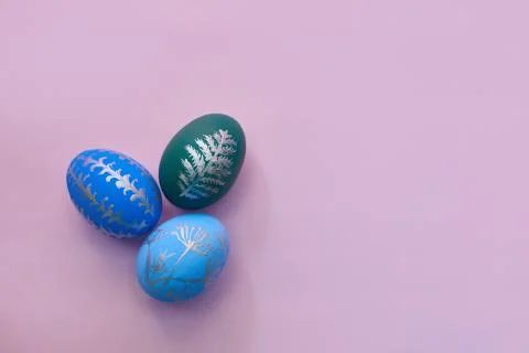 Painted easter eggs on pink background top view. flat lay with copy space Stock Photos