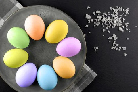 Painted Easter eggs on a plate on a black background.Happy Easter Stock Photos