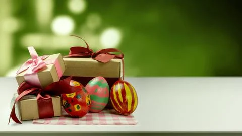 Painted Easter eggs with unique patterns and three brown gift boxes tied wi.. Stock Photos