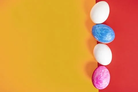 Painted Easter eggs on a vibrant red and yellow background Stock Photos