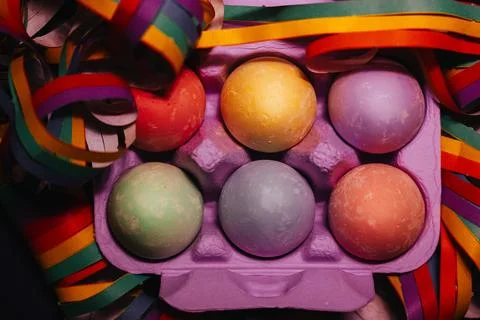 Painted Easter eggs in violet box flatly. Egg decorating LGBT gay vibrant colors Stock Photos