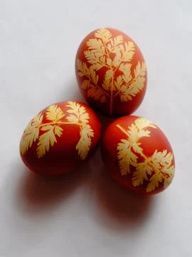 Painted Easter eggs on a white background. Floral pattern on a red eggshell. Stock Photos