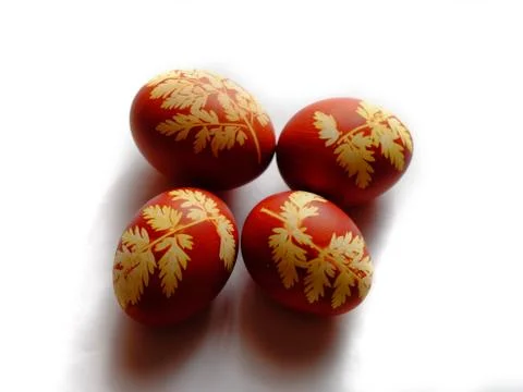 Painted Easter eggs on a white background. Floral pattern on a red eggshell. Stock Photos