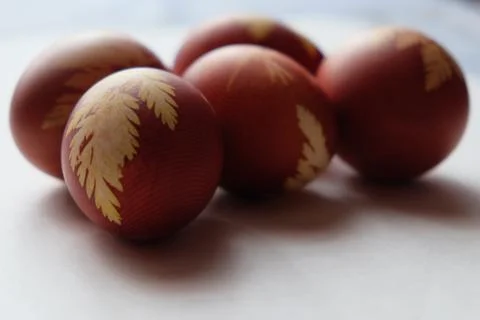 Painted Easter eggs on a white background. Floral pattern on a red eggshell. Stock Photos