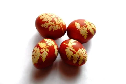 Painted Easter eggs on a white background. Floral pattern on a red eggshell. Stock Photos