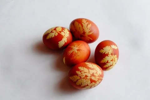 Painted Easter eggs on a white background. Floral pattern on a red eggshell. Stock Photos