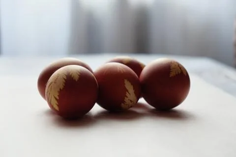 Painted Easter eggs on a white background. Floral pattern on a red eggshell. Stock Photos