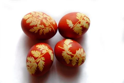 Painted Easter eggs on a white background. Floral pattern on a red eggshell. Stock Photos