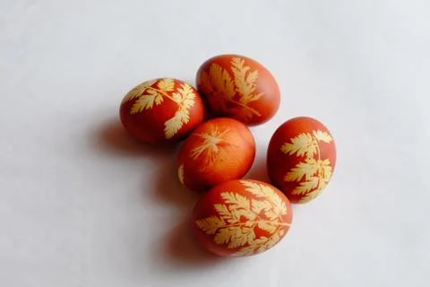Painted Easter eggs on a white background. Floral pattern on a red eggshell. Stock Photos