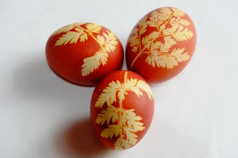 Painted Easter eggs on a white background. Floral pattern on a red eggshell. Stock Photos