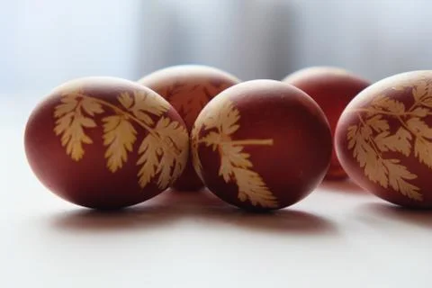 Painted Easter eggs on a white background. Floral pattern on a red eggshell. Stock Photos