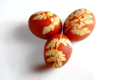 Painted Easter eggs on a white background. Floral pattern on a red eggshell. Stock Photos