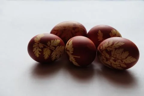 Painted Easter eggs on a white background. Floral pattern on a red eggshell. Stock Photos