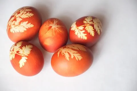 Painted Easter eggs on a white background. Floral pattern on a red eggshell. Stock Photos
