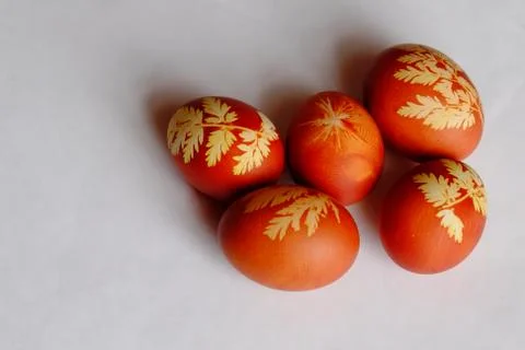 Painted Easter eggs on a white background. Floral pattern on a red eggshell. Stock Photos