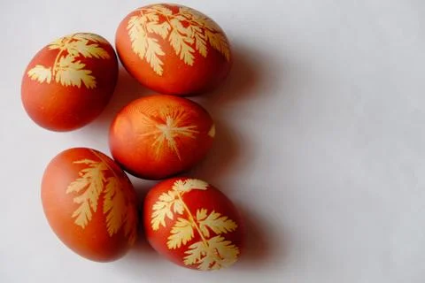 Painted Easter eggs on a white background. Floral pattern on a red eggshell. Stock Photos