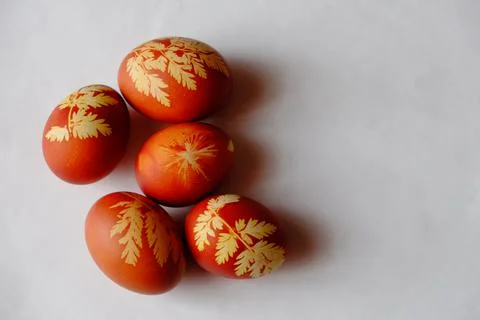 Painted Easter eggs on a white background. Floral pattern on a red eggshell. Stock Photos