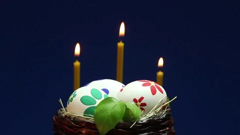 Painted Easter eggs in a wicker basket that spins on the background of burning c 動画素材 73019017