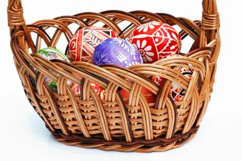 Painted easter eggs in wicker basket Stock Photos