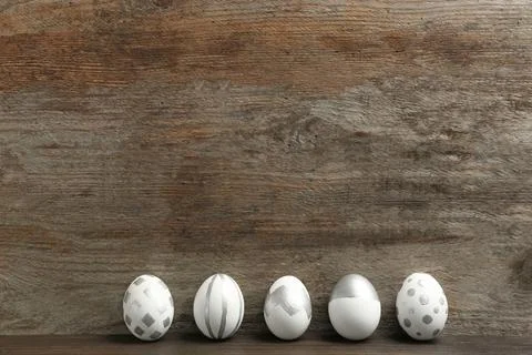 Painted Easter eggs on wooden background. Space for text Stock Photos