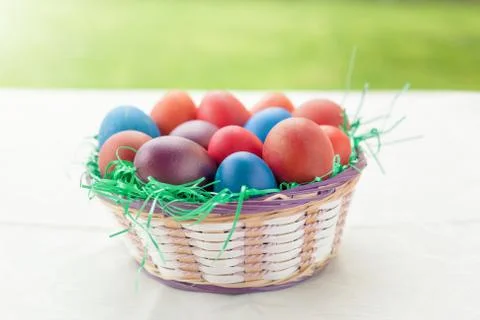 Painted eggs in basket as decoration for Easter Stock Photos