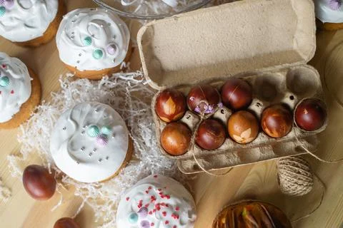 Painted eggs cooked for Easter are in the tray near the pies Stock Photos