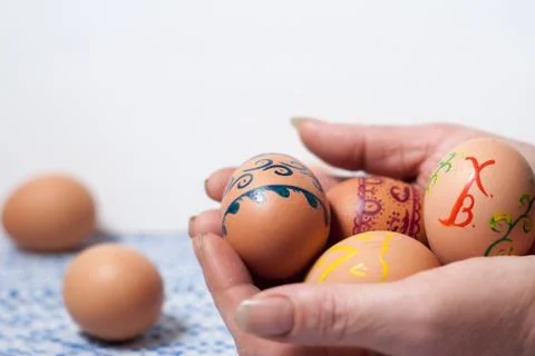 Painted eggs on hand Stock Photos