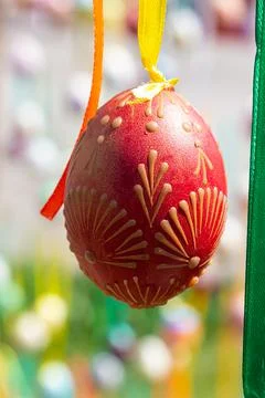 Painted eggs hang from the branches of the Easter tree. The focus is on a yel Stock Photos