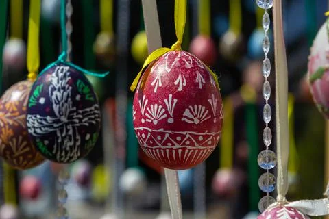 Painted eggs hang from the branches of the Easter tree. The focus is on a yel Stock Photos