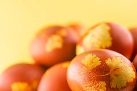 Painted eggs on a yellow background for the Easter holiday Stock Photos