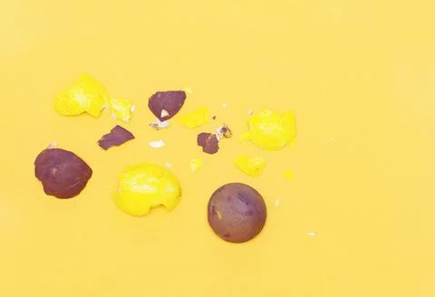 Painted eggshell on a yellow pastel background. Stock Photos