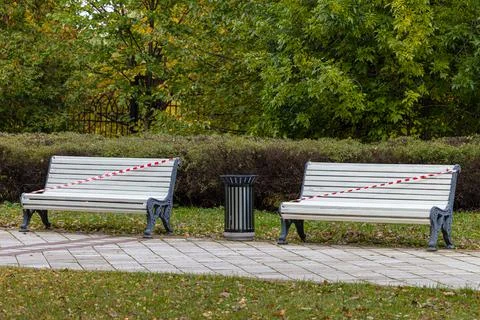 Painted empty park bench with red ribbon Stock Photos