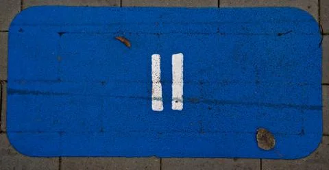 Painted equals on a pavement blue background Stock Photos
