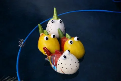 Painted fish floating in pool Stock Photos