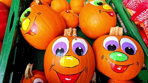 Painted funny faces on decorative pumpkins in display box Stock-Footage 348036566
