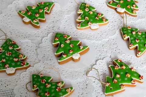 Painted gingerbread in the shape of Christmas tree on a white napkin background Stock Photos