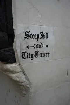Painted gothic direction sign to Steep Hill and City Centre in Lincoln Stock Photos