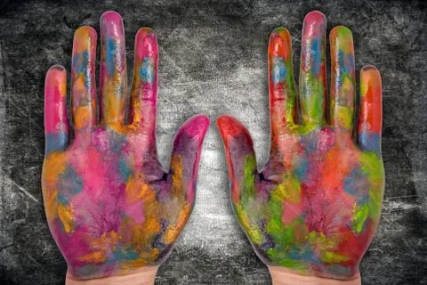 Painted human hands on dark background Stock Photos