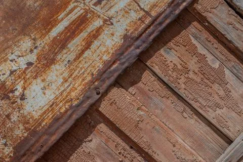 Painted iron surface with a large rusty and metal corrosion and old wooden Stock Photos