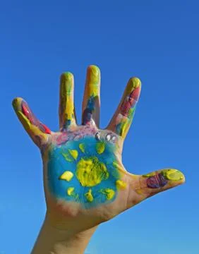 Painted kid hand Stock Photos