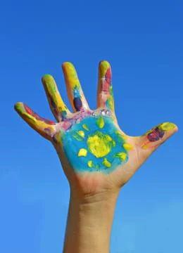 Painted kid hand Stock Photos